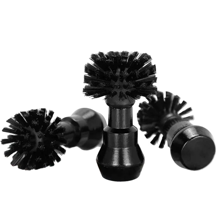Black scrubber brushes on a white background with brown powder.
