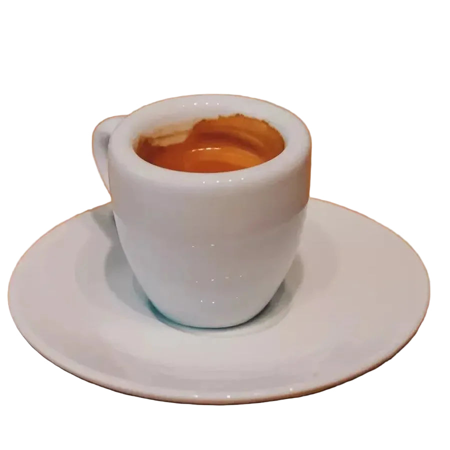 White espresso cup with a small amount of coffee on a wooden table