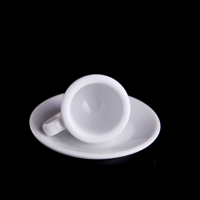 White ceramic cup and saucer on a black background